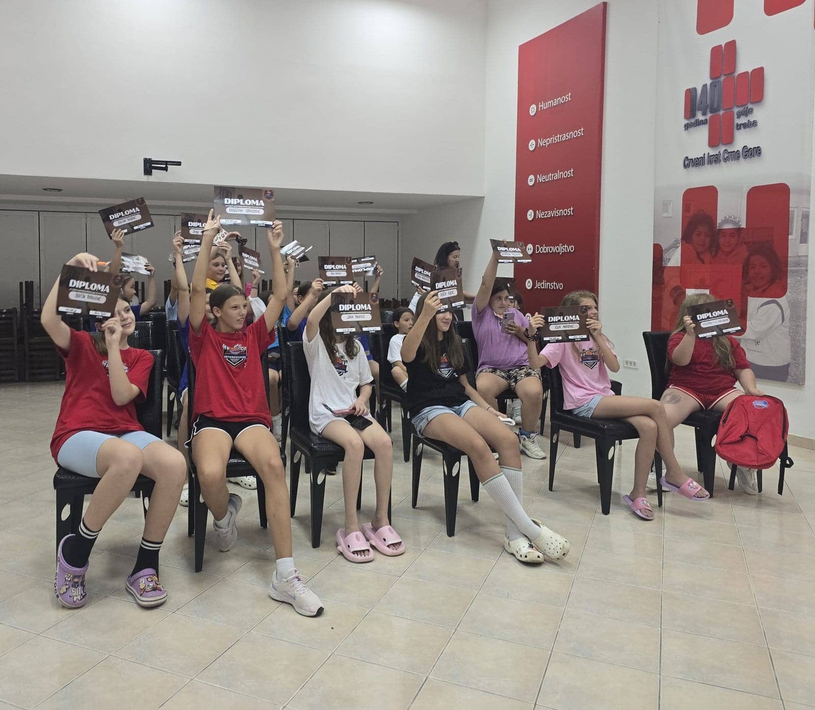 Campers holding up their participation diplomas
