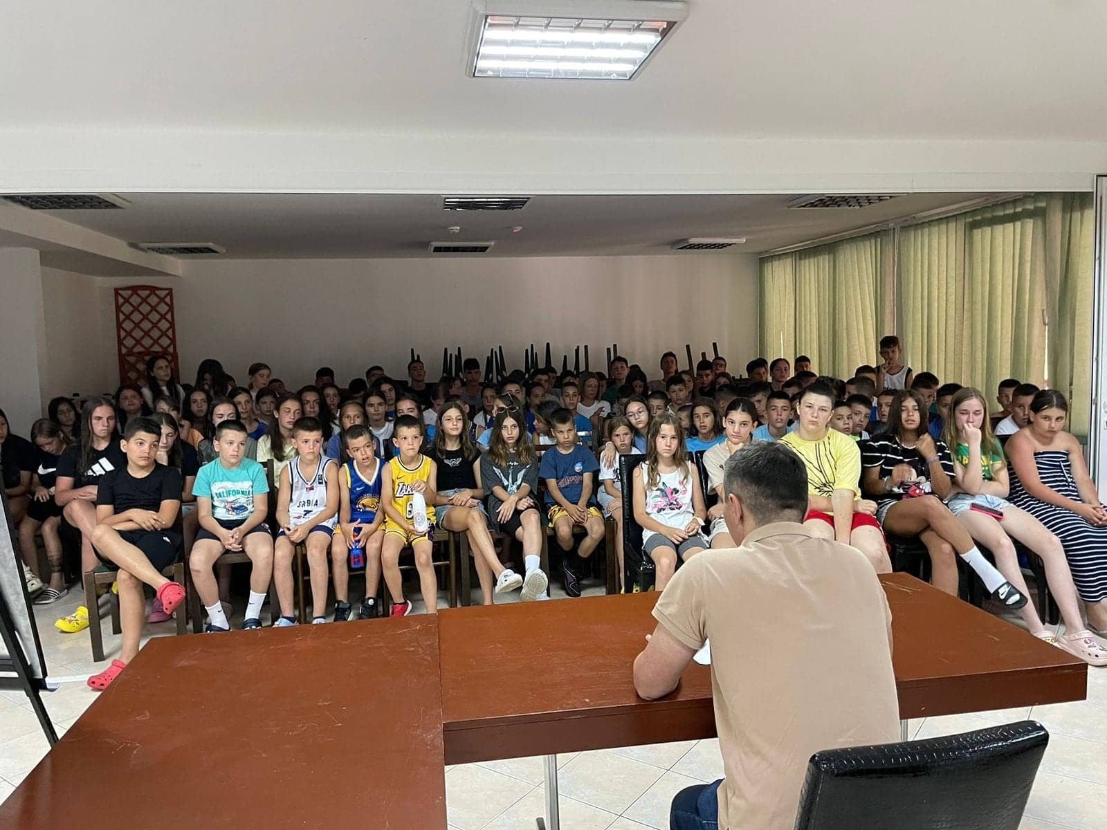 An educational talk — a full room of campers listening to the speaker
